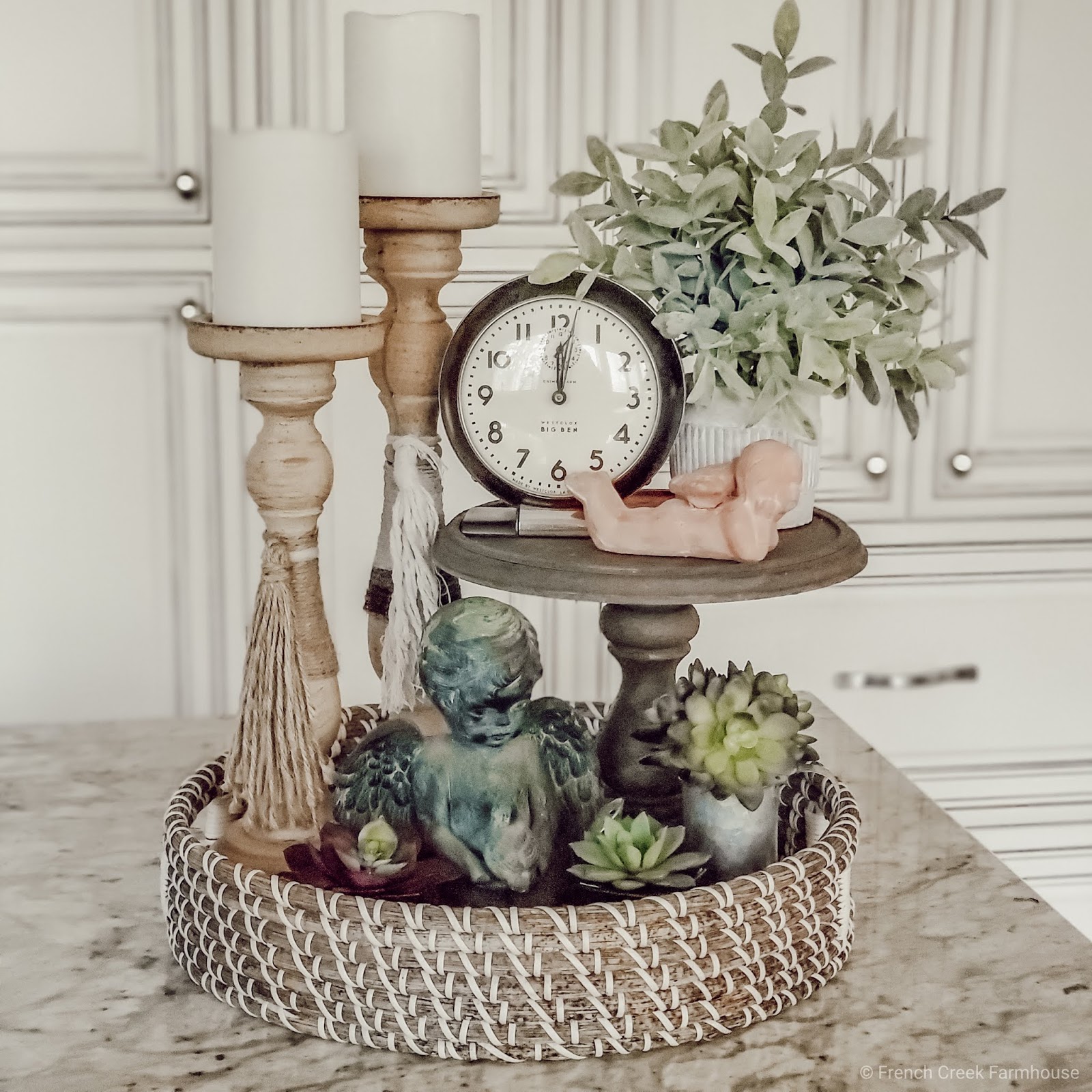 A tiered tray decorated for Valentine's Day with cupid and angel decor