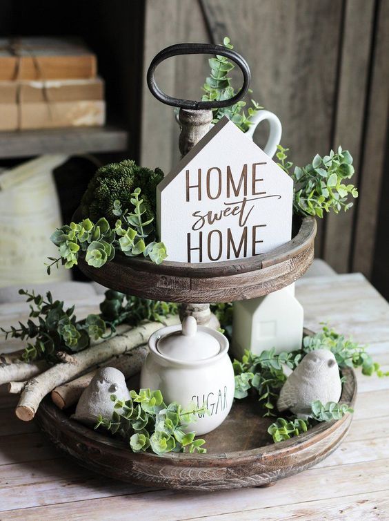 Two-tier wooden tray with greenery and home sweet home sign