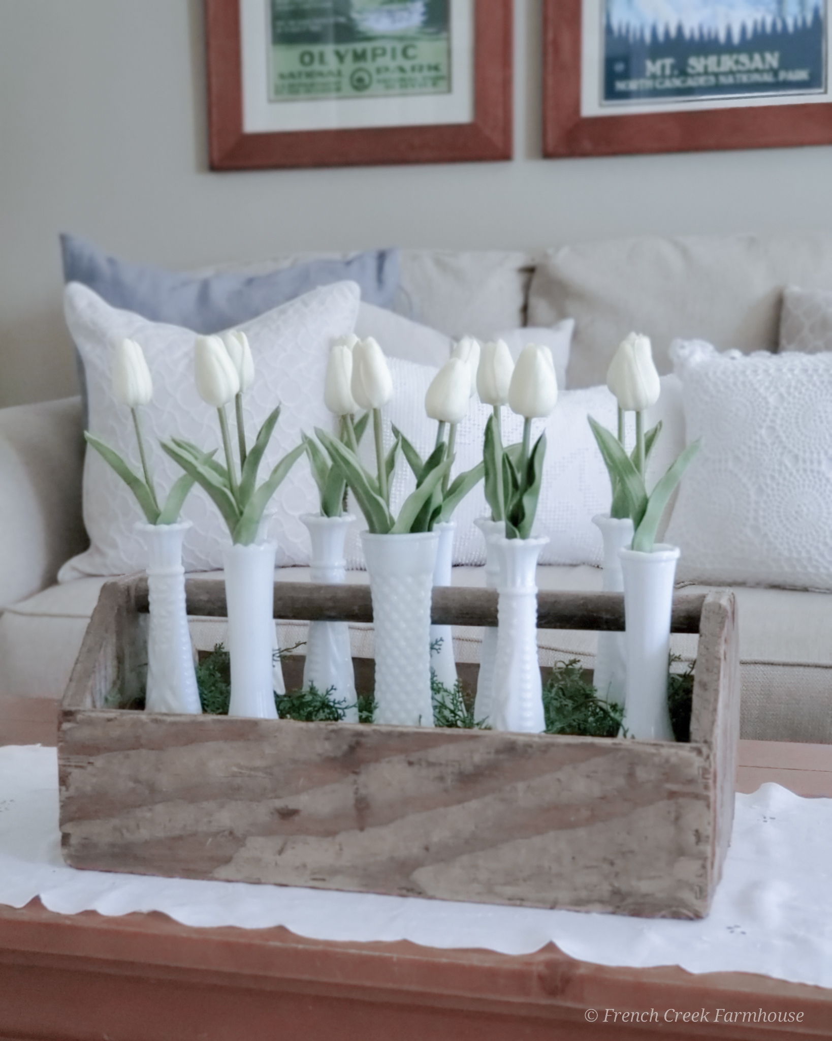 Modern farmhouse spring living room with white tulips in milk glass vases