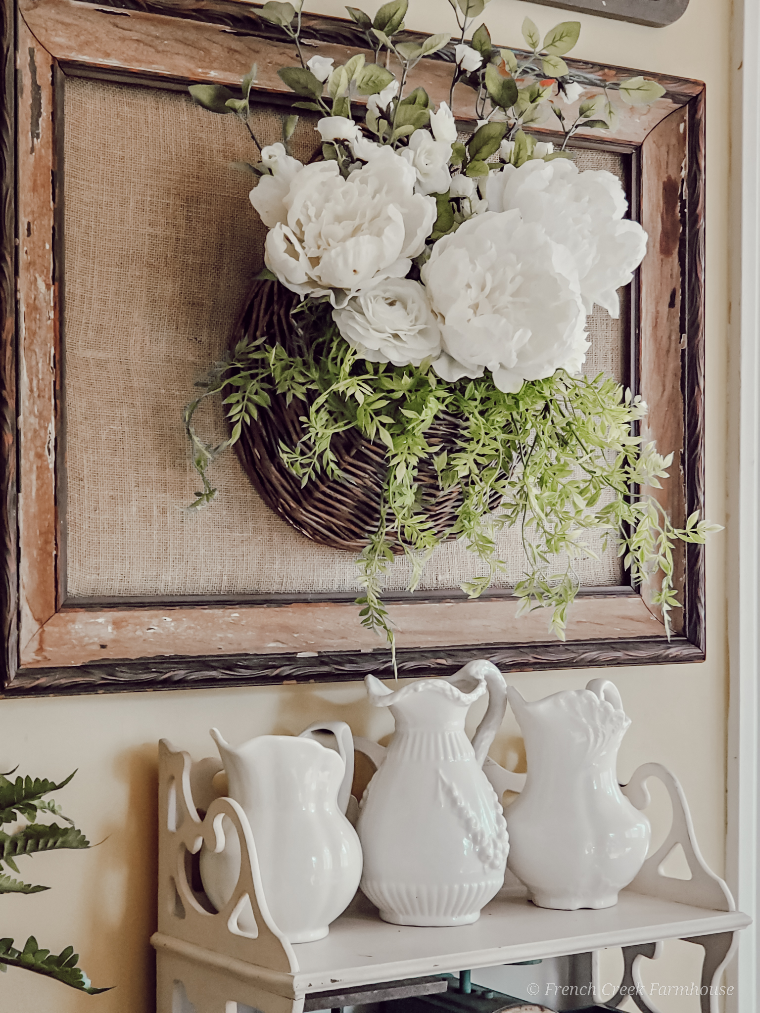 Wall hanging basket filled with white peonies