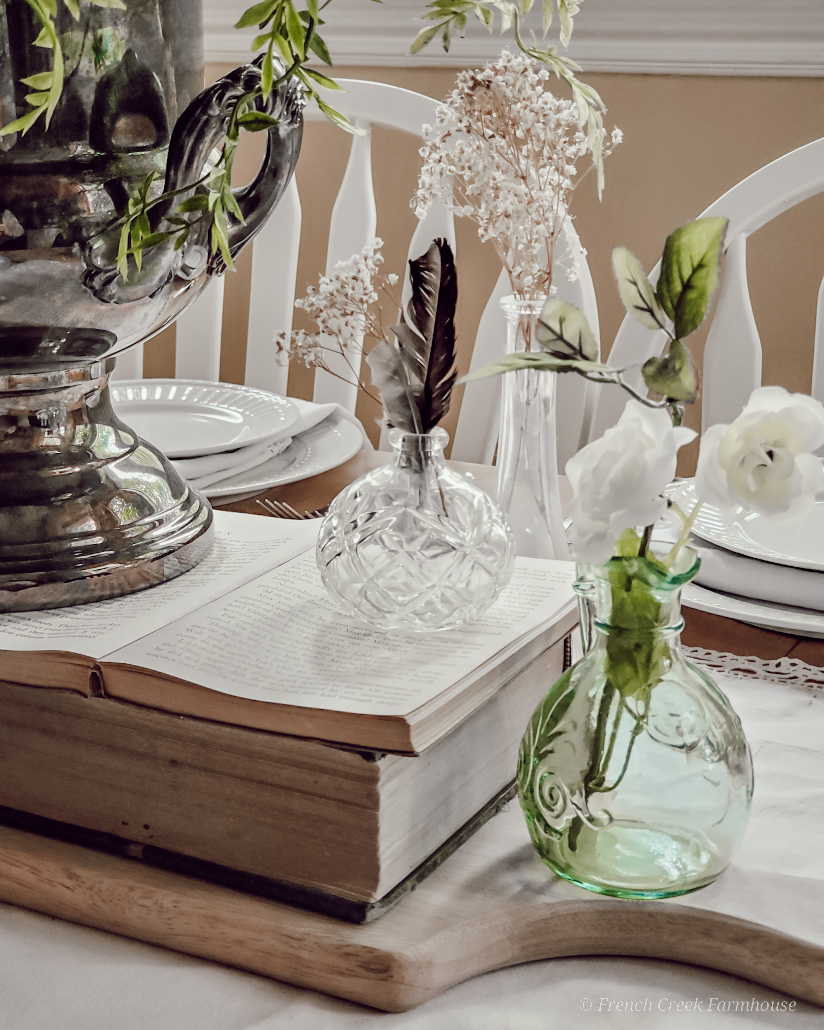 Small vintage vases and old books used for a romantic centerpiece