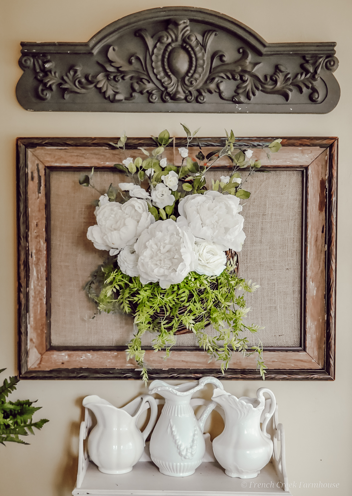 An old picture frame is a beautiful backdrop for floral arrangements