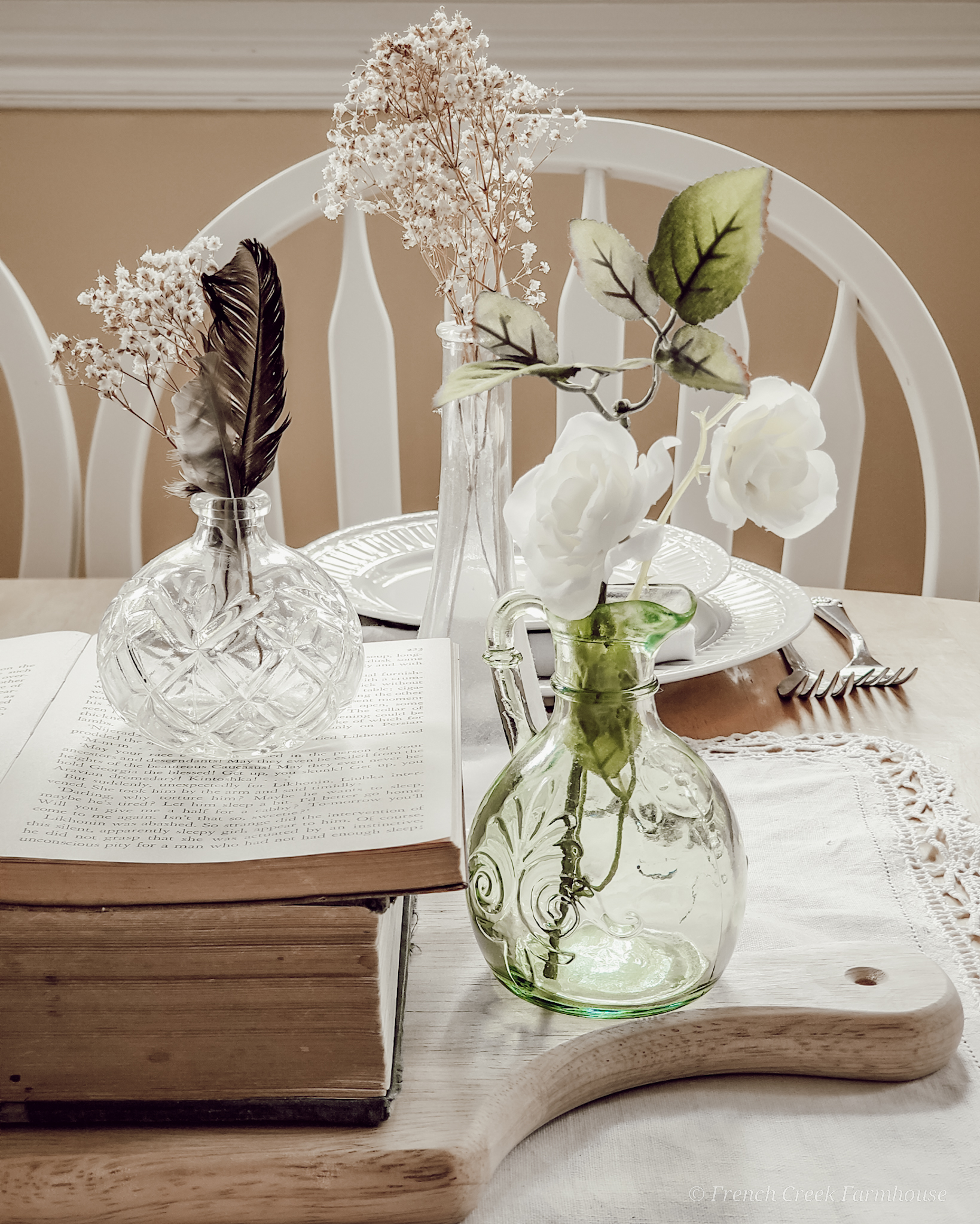Small vintage glass vases filled with baby's breath as a centerpiece