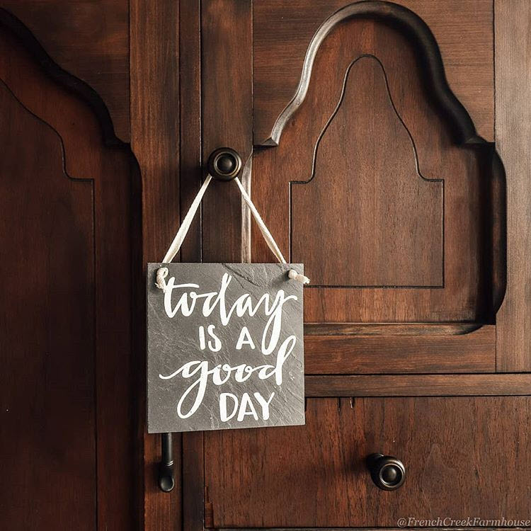 Hanging a small sign with an uplifting saying on a furniture knob makes a farmhouse chic statement
