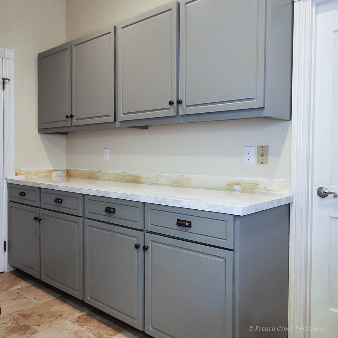 After: Modern gray cabinets with white marble countertops