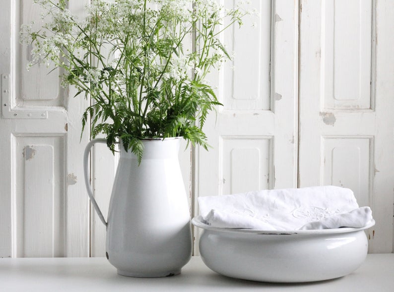 A large vintage enamelware pitcher and wash basin