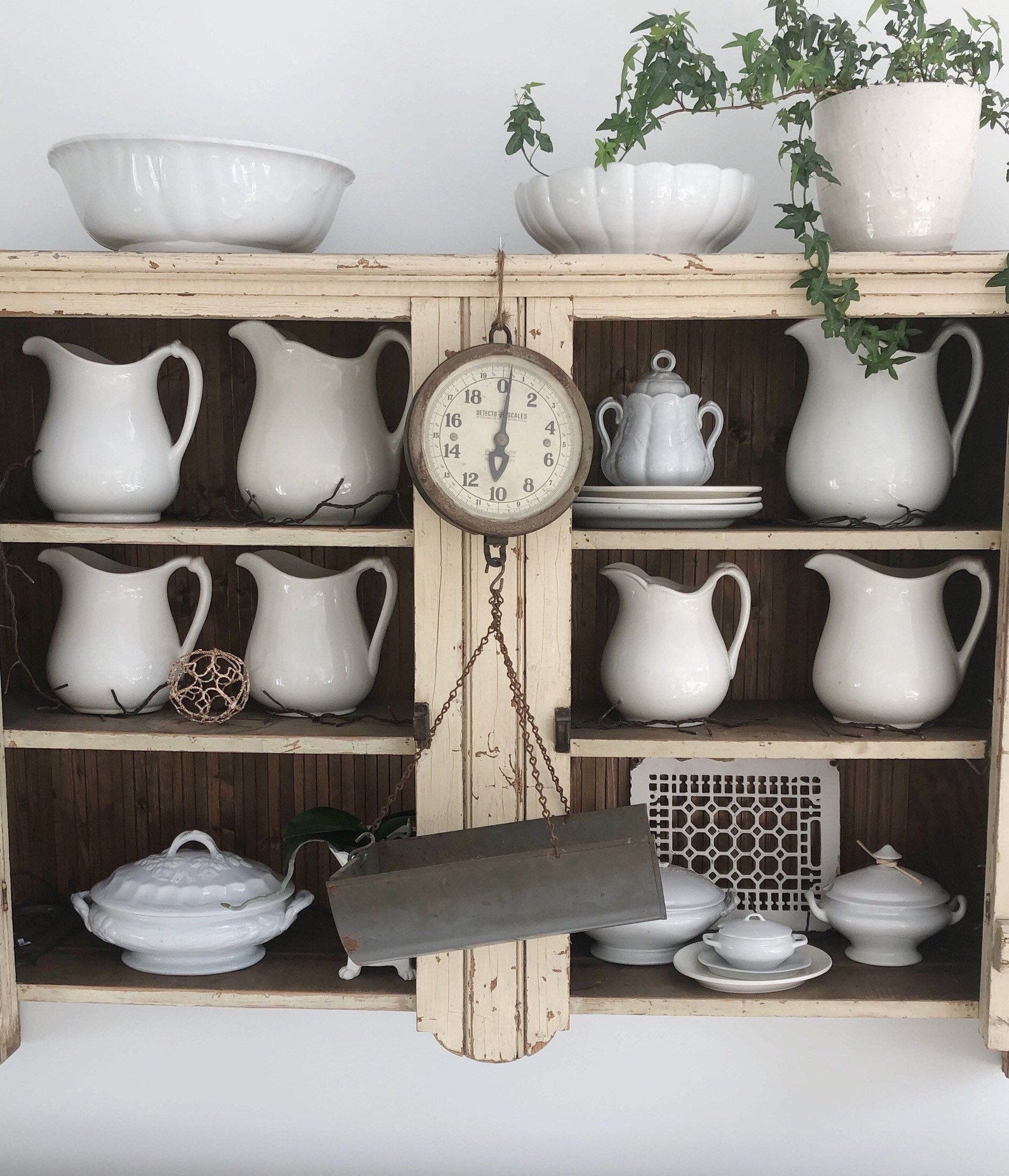 Ironstone pitcher collection in a vintage hutch cabinet