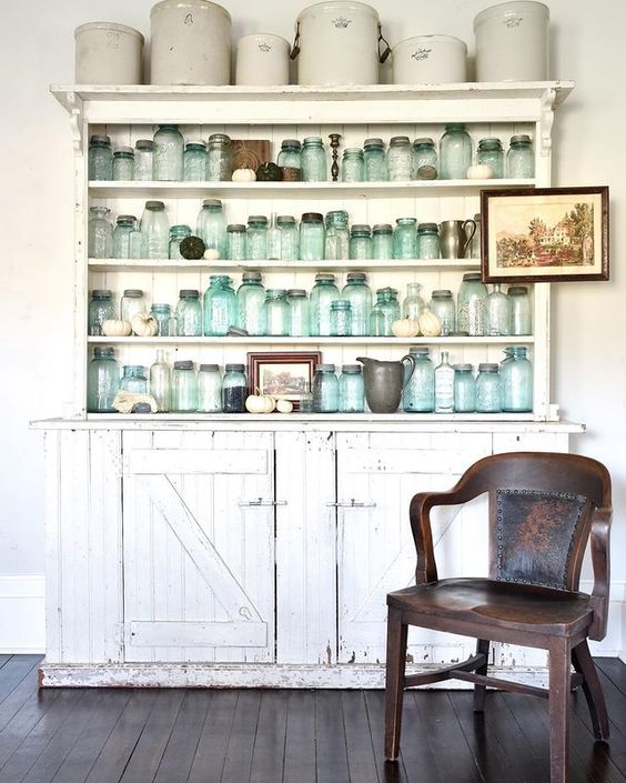 Vintage blue mason jars in a chippy hutch are a beautiful reminder of the past
