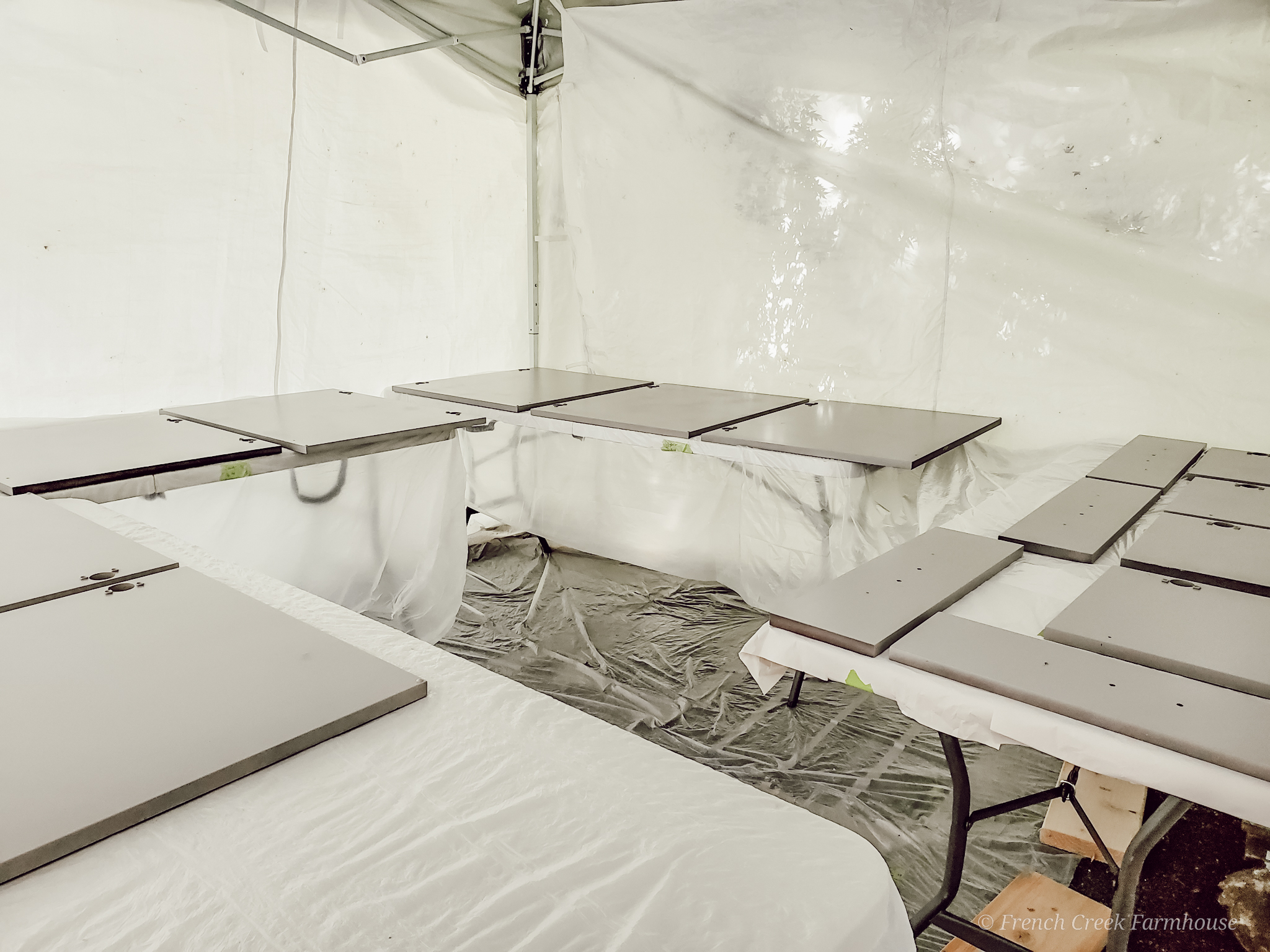 Painting Cabinet Doors Using a 10x10 pop-up canopy is a simple way to create a paint booth