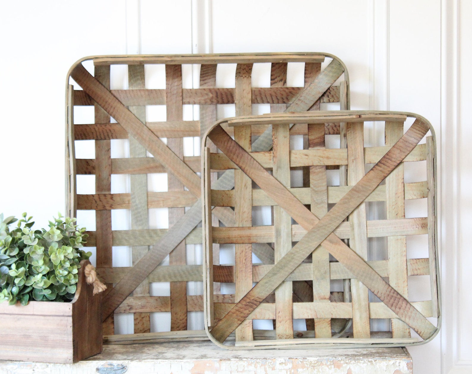 A pair of handmade tobacco baskets add to the vintage aesthetic of a fireplace mantel