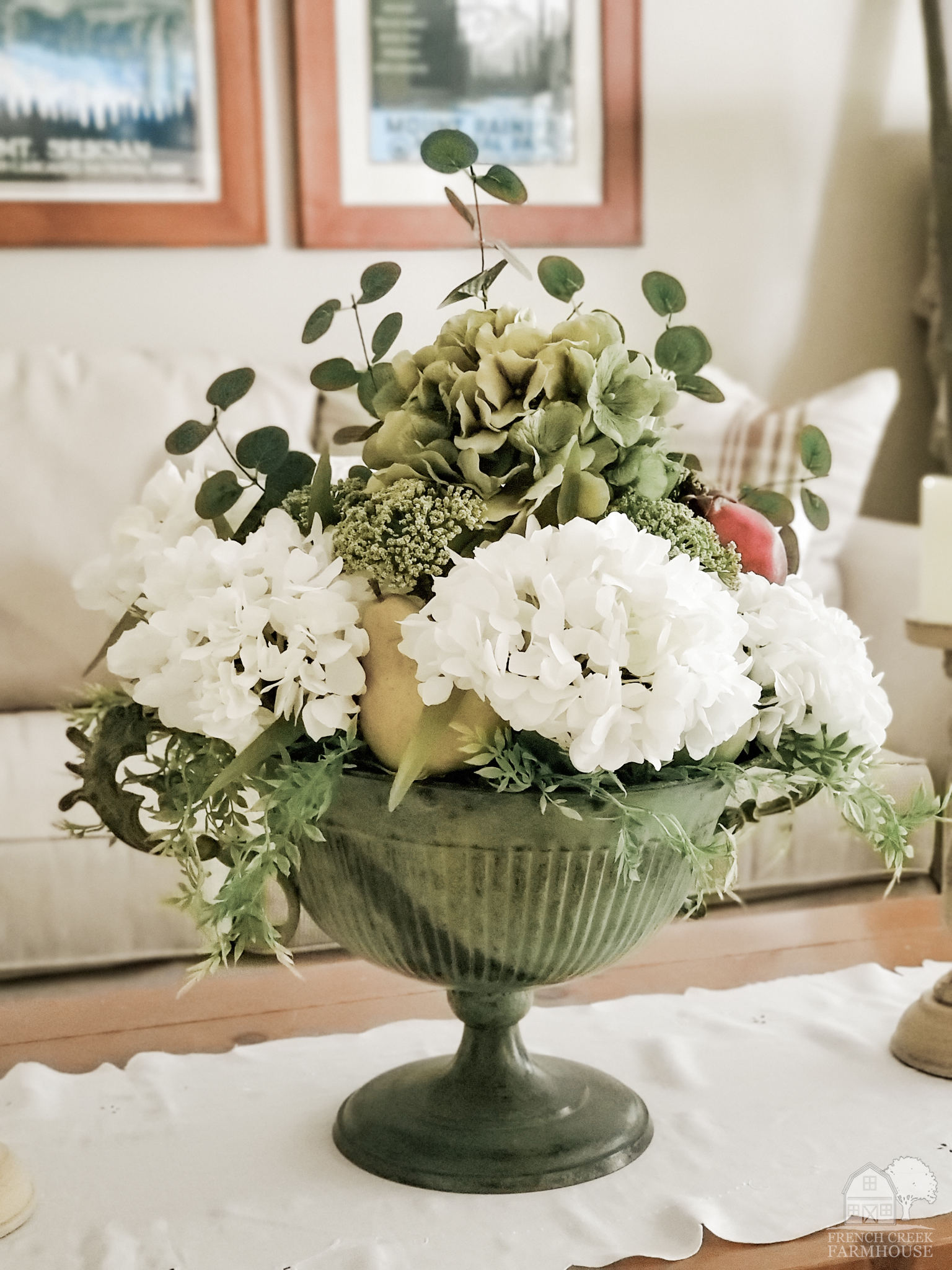 Fall florals and fruits are used to make a large centerpiece