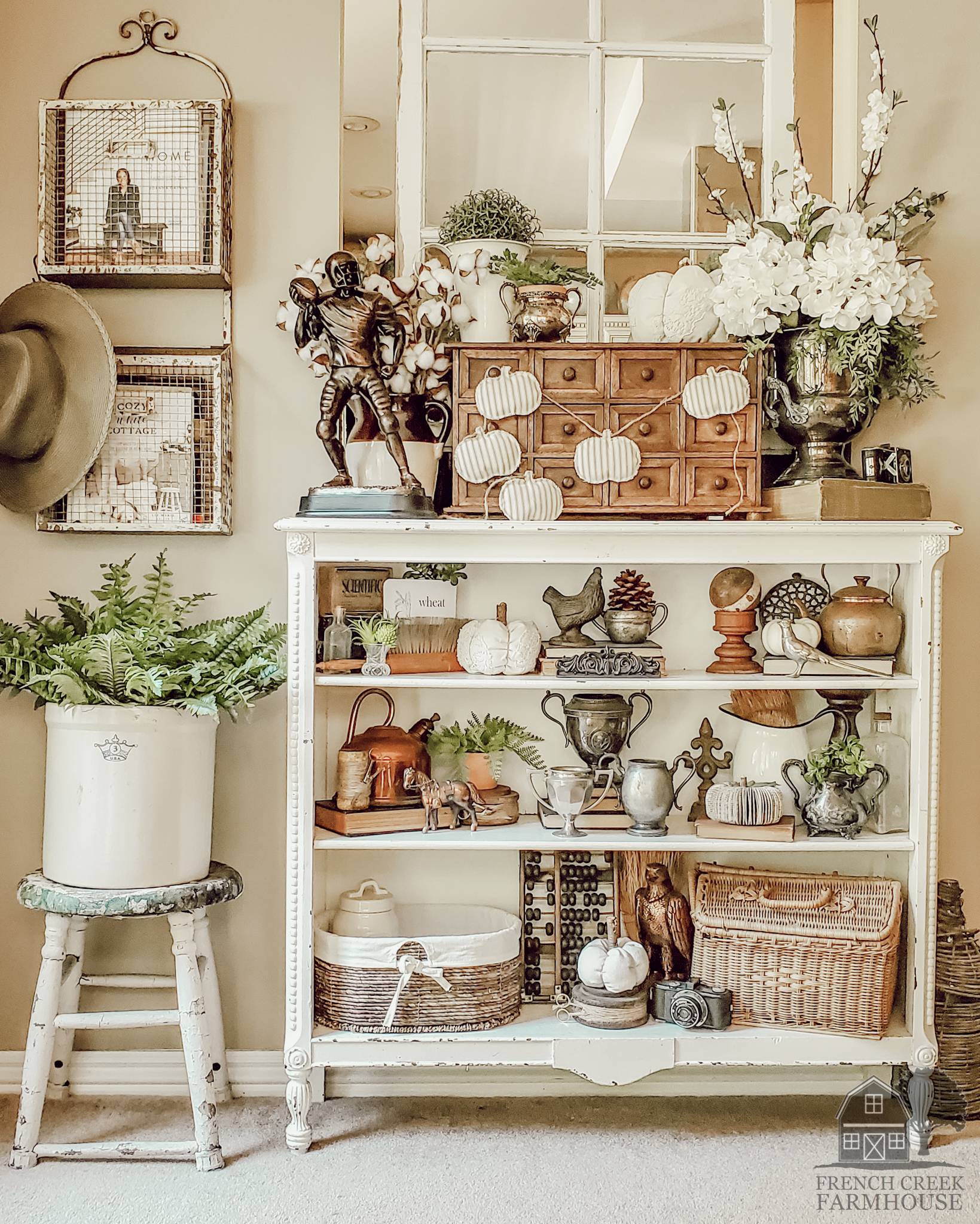 Antique bookshelves are decorated with vintage items for fall