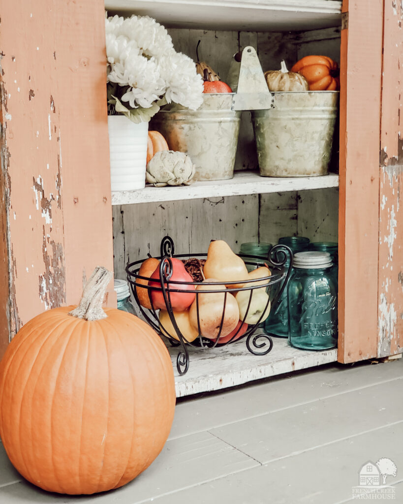 Pumpkins and vintage decor on the porch