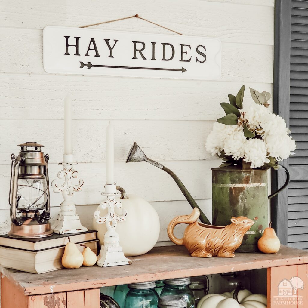 Fall decor on top of a chippy vintage jelly cupboard