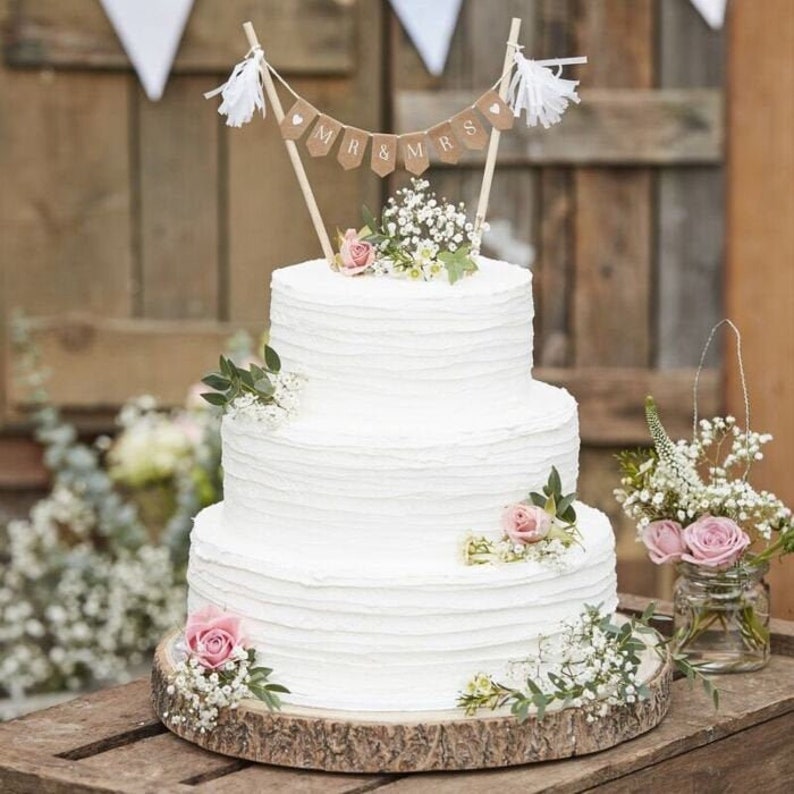 A wedding cake topped with a mini bunting banner