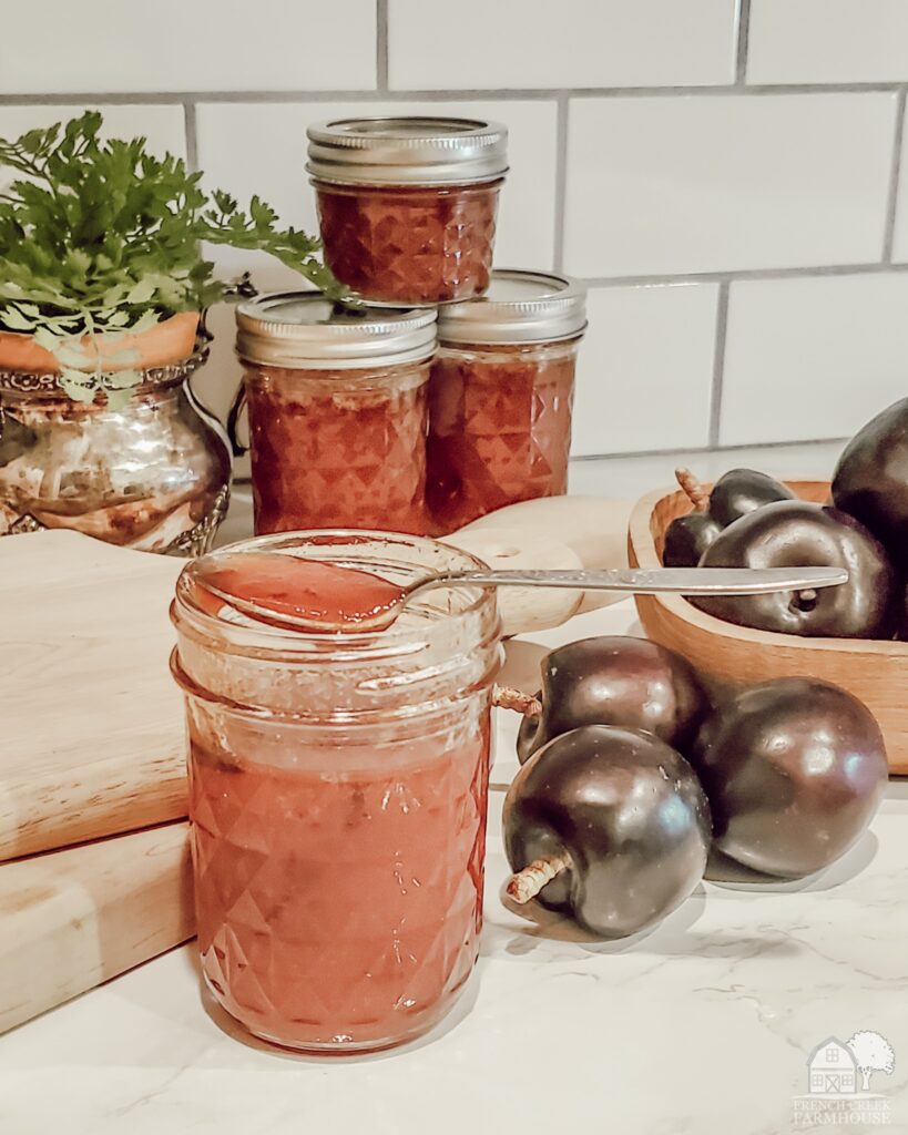 Jars of plum preserves in a farmhouse kitchen