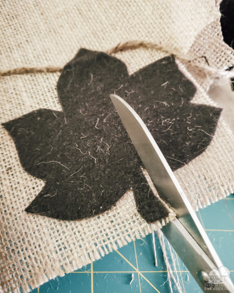 Cutting out burlap leaves with felt backing