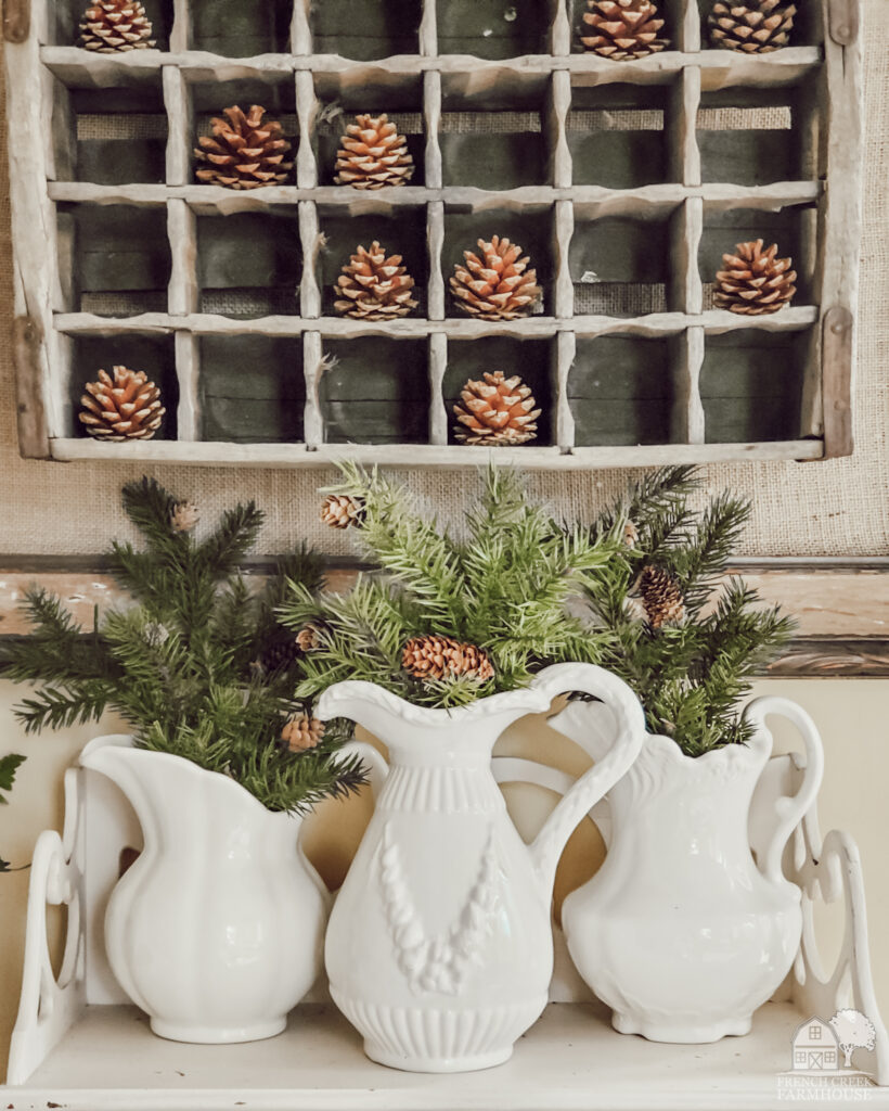 Ironstone pitchers filled with evergreen branches are perfect for winter farmhouse decorating