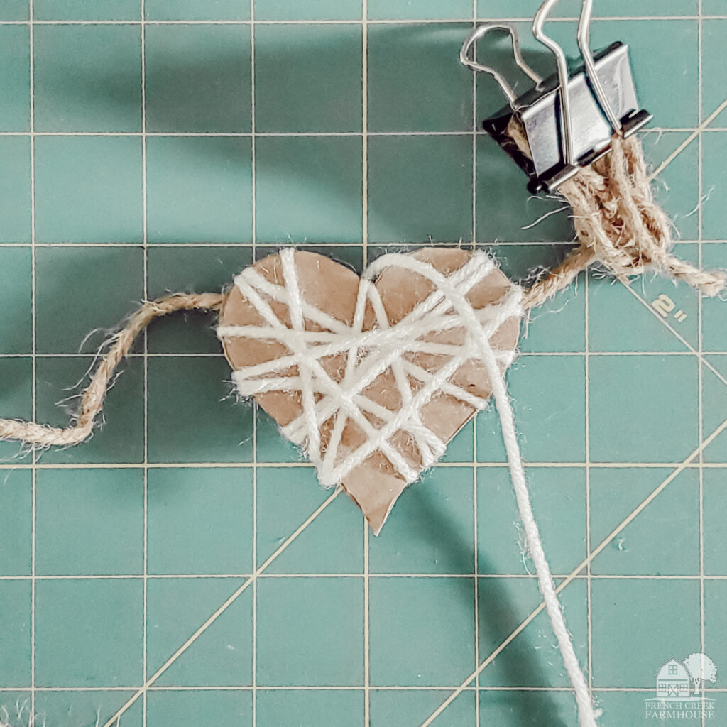Making a yarn wrapped hearts garland is easy with my free printable pattern