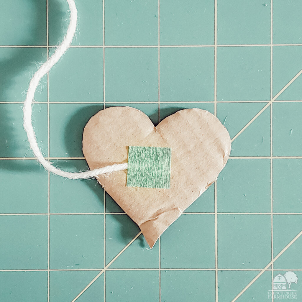 Make a yarn wrapped hearts garland with this free printable pattern