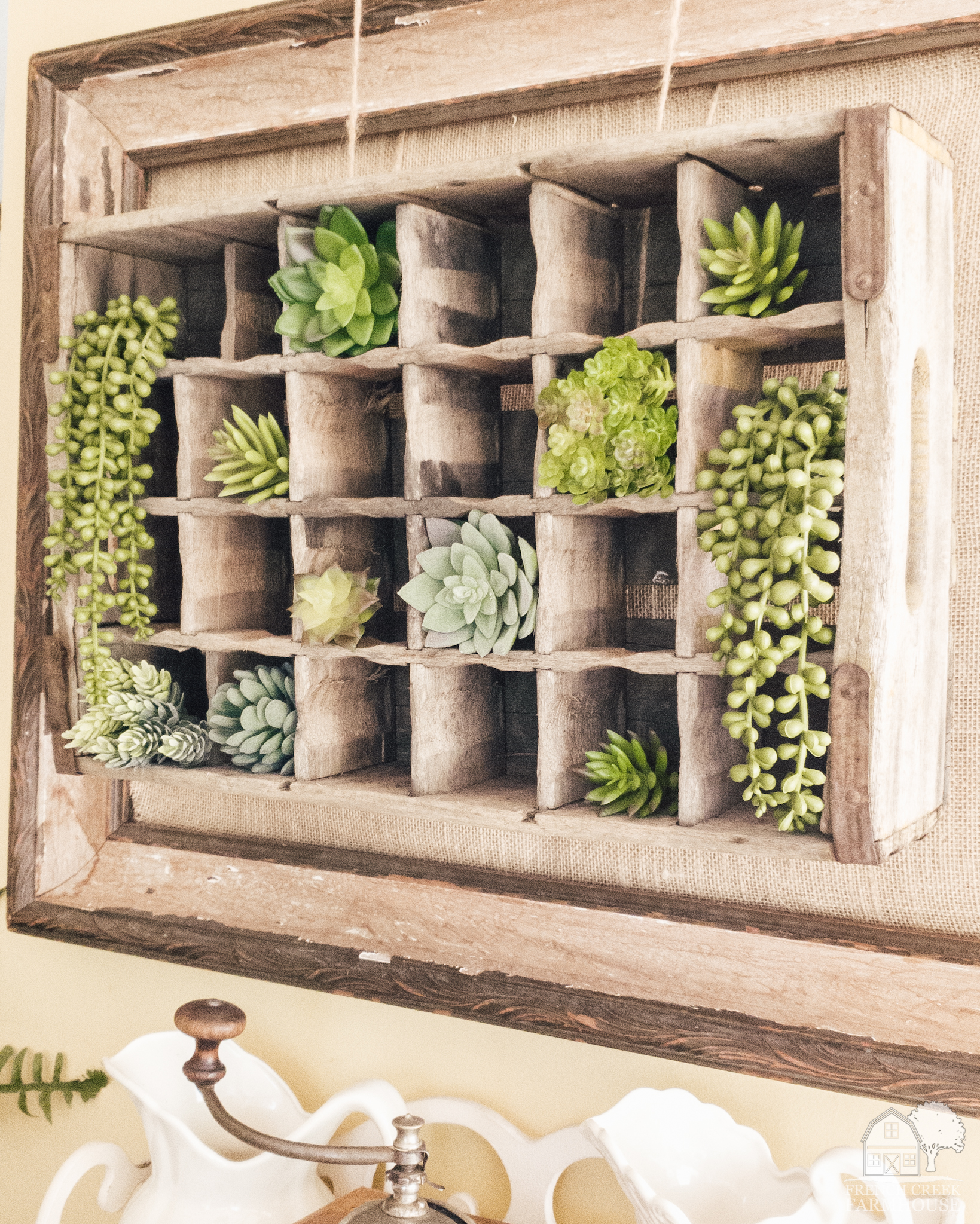 Succulents in a wooden crate make a rustic wall arrangement