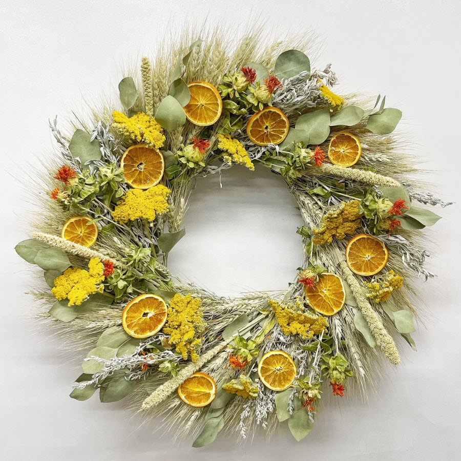 Dehydrated orange slices with locally grown dried flowers make a beautiful fall wreath.