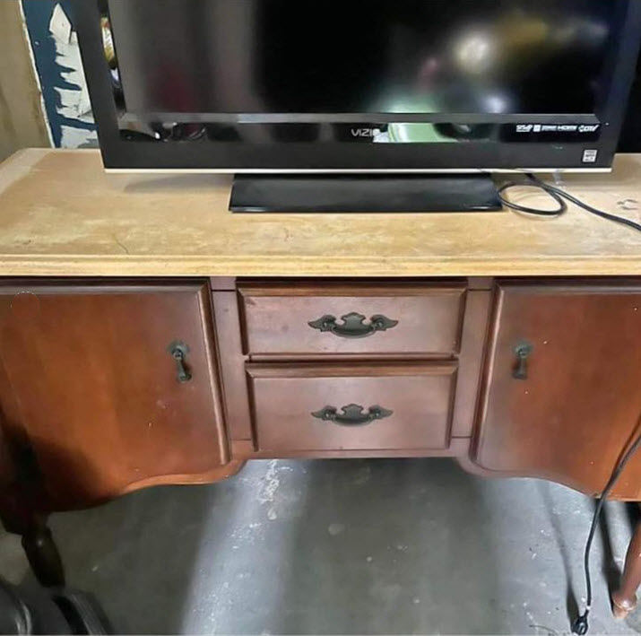 With two different types of wood, visible water damage, and scratches, most people would ignore this vintage buffet. But it's a perfect piece for a refinishing project!