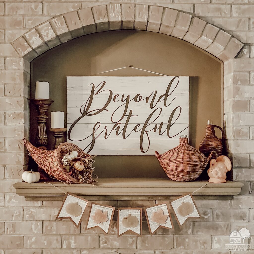 Using a subtle and neutral color palette with vintage decor items creates a Thanksgiving mantel that adds cozy elegance and rustic sophistication.