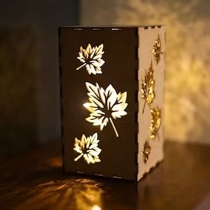 Wooden lantern with autumn leaf cutouts