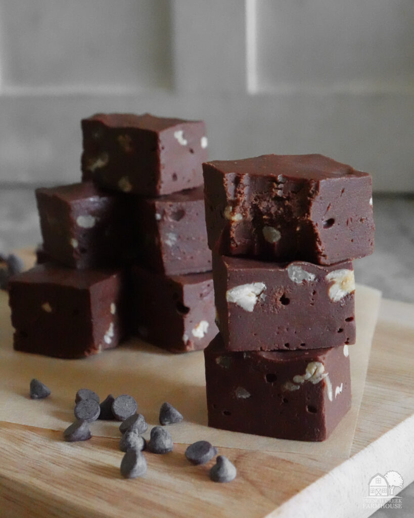 Pieces of fudge stacked vertically with a bite missing from the top piece