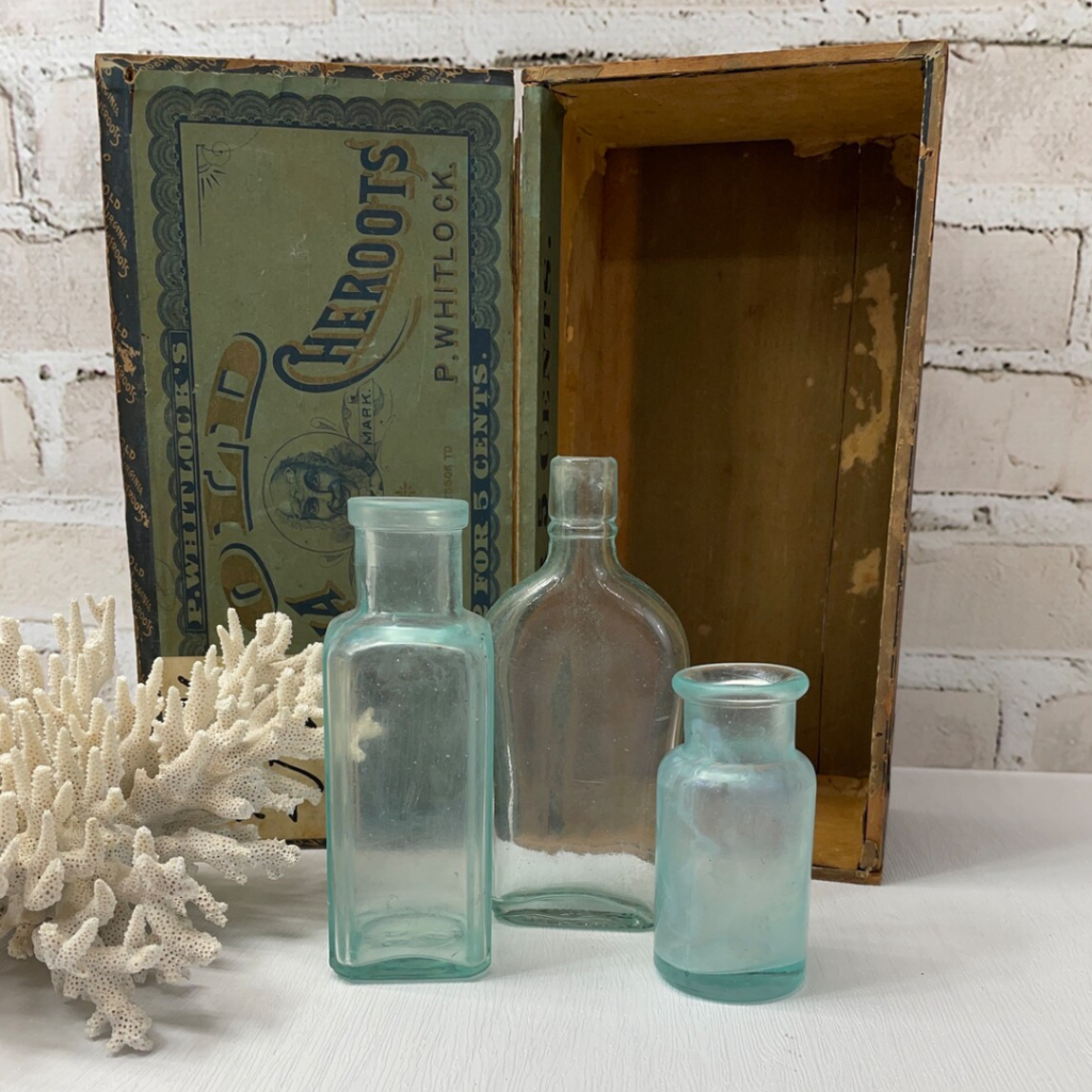 Vintage green glass bottles in varying sizes and shapes
